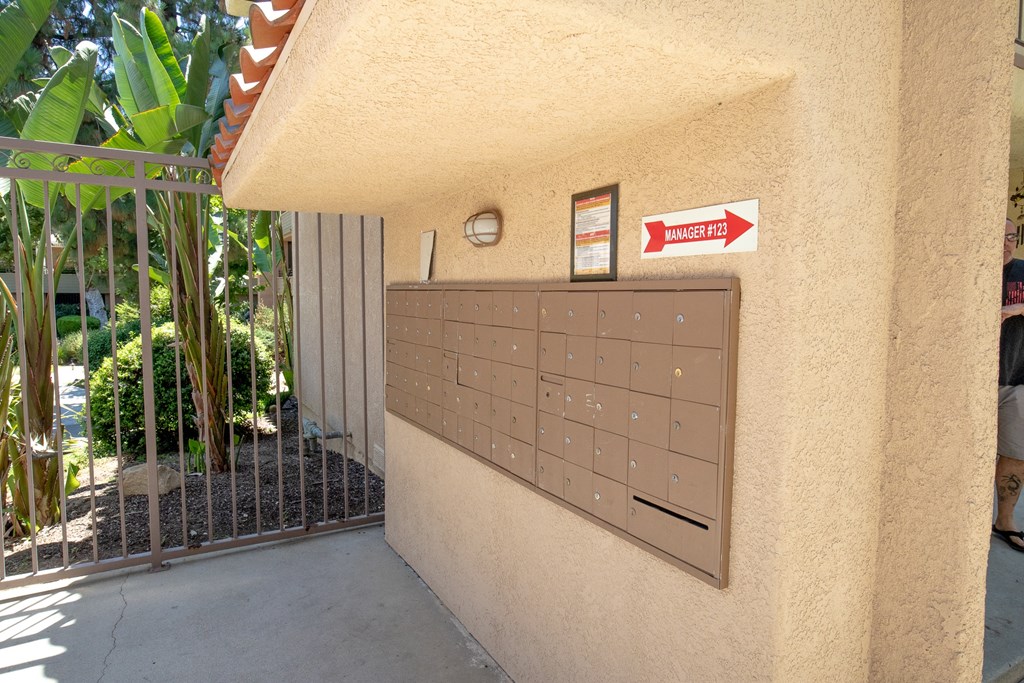 a garage door with a mailbox and a sign on the side