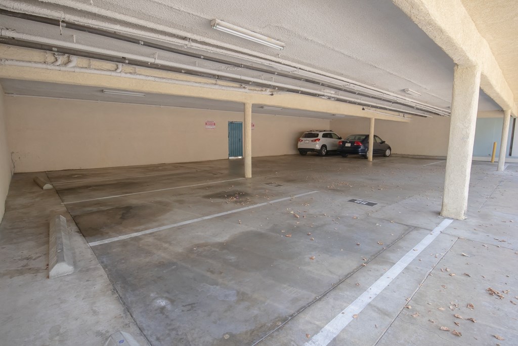 a parking garage with two cars in it