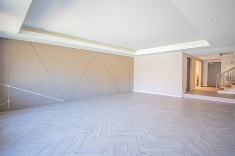 a large empty room with white walls and a wooden floor