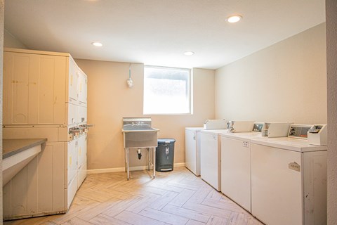 A kitchen with white appliances and a window.
