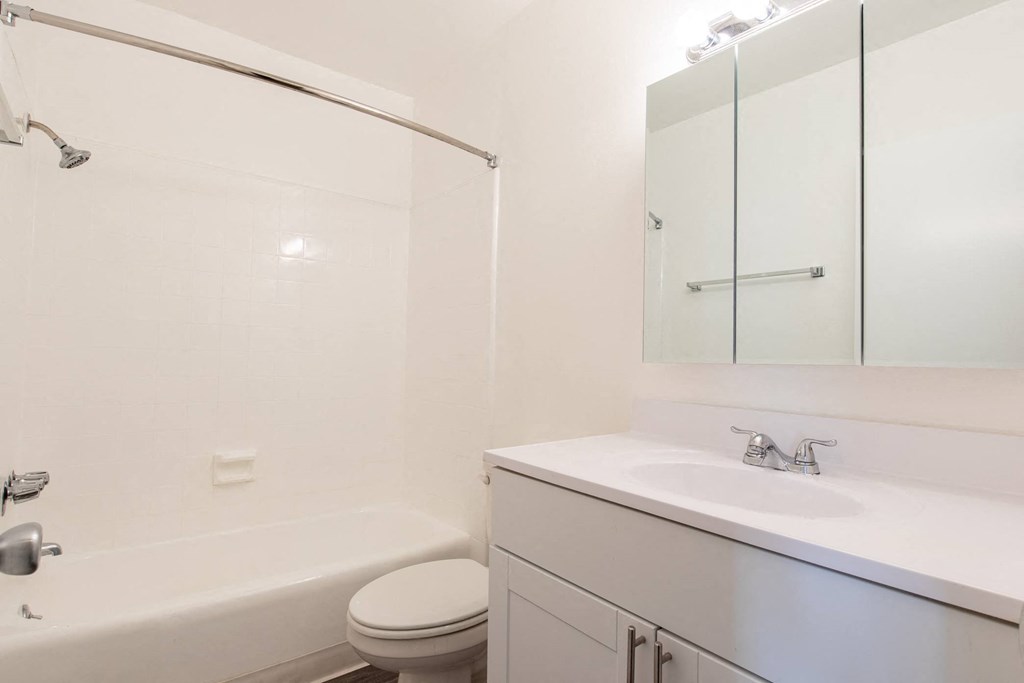 a bathroom with a sink toilet and a bath tub