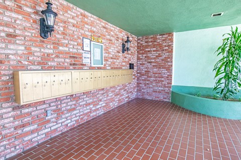 a room with a brick wall and a plant