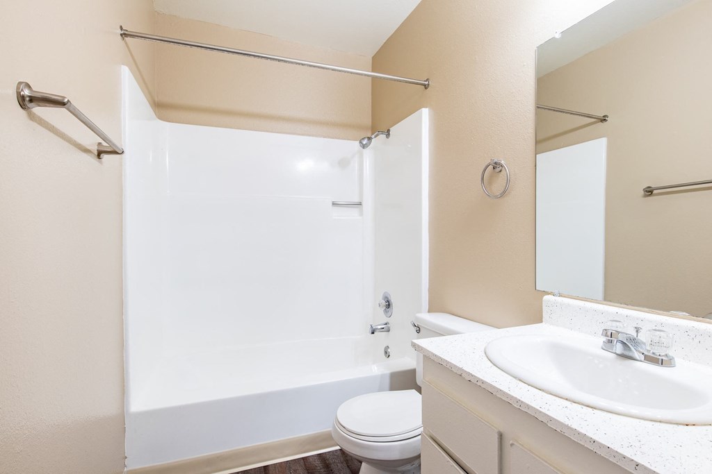 a bathroom with a shower and a sink and a toilet