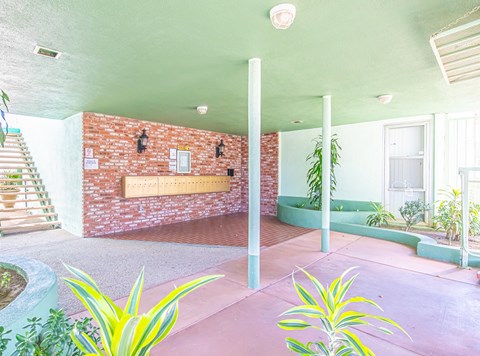 a bathroom with a brick wall and a green tub in the corner