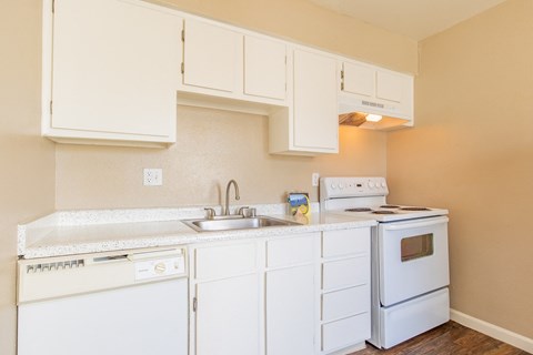 a kitchen with white appliances and white cabinets