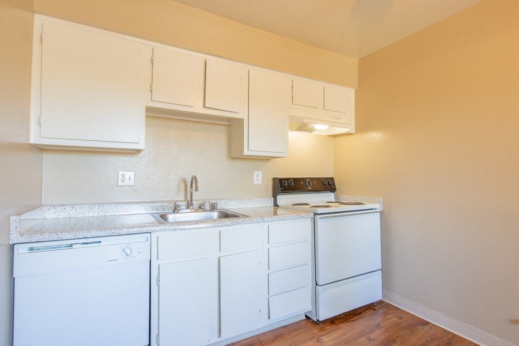 a kitchen with white appliances and white cabinets