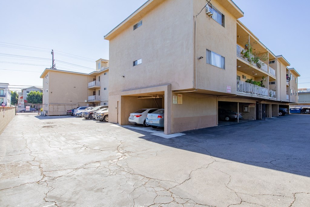 a building with a parking lot and cars in front of it