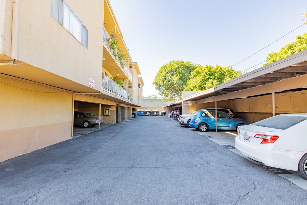 the view of a parking lot with cars parked next to a building