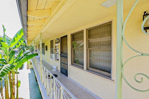 a building with windows and a balcony with a porch