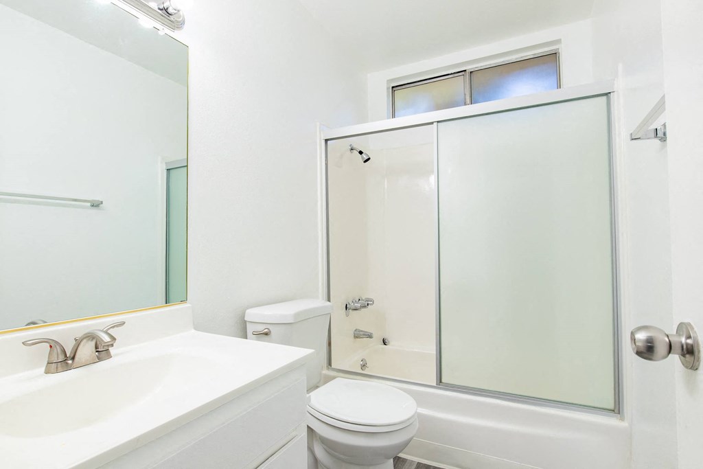 a bathroom with a sink toilet and a shower