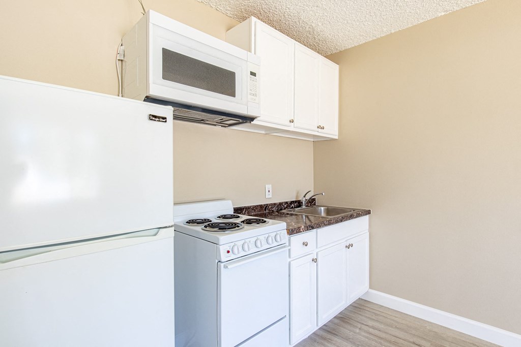 a kitchen with a stove microwave and refrigerator