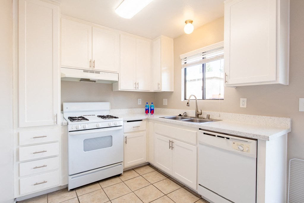 a kitchen with white appliances and white cabinets