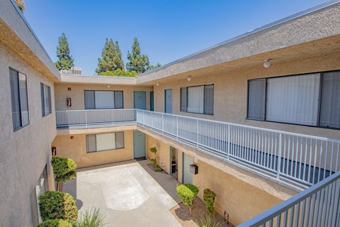 the outlook of a building with balconies and a courtyard