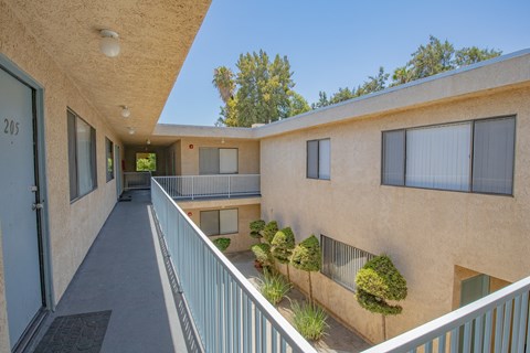 the outlook of a building with a long balcony and a courtyard