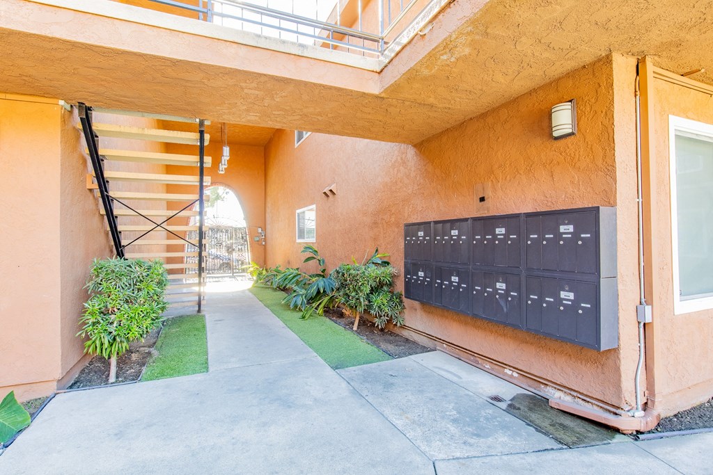 the entrance to a building with a mailbox and a staircase
