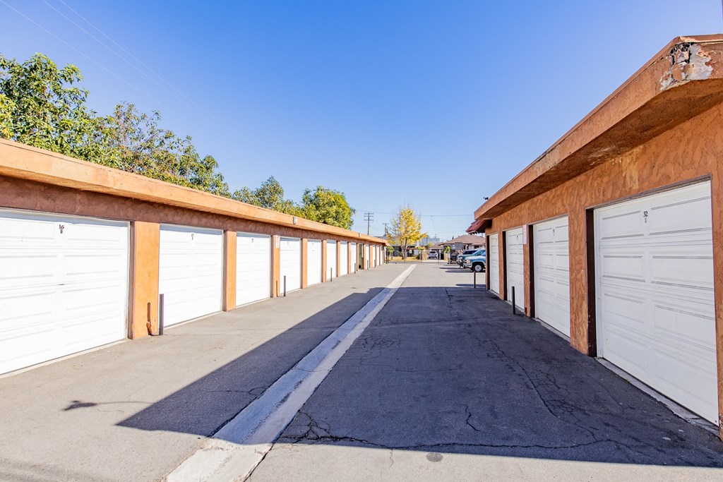 a row of garages with white garage doors