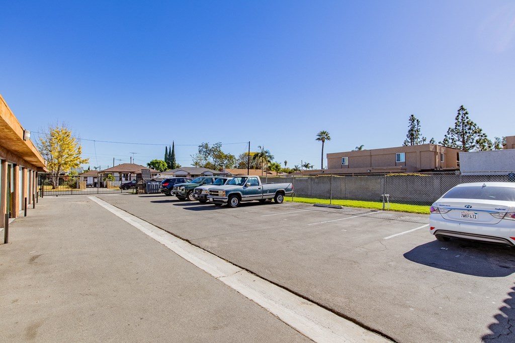 a parking lot with cars parked in front of a building