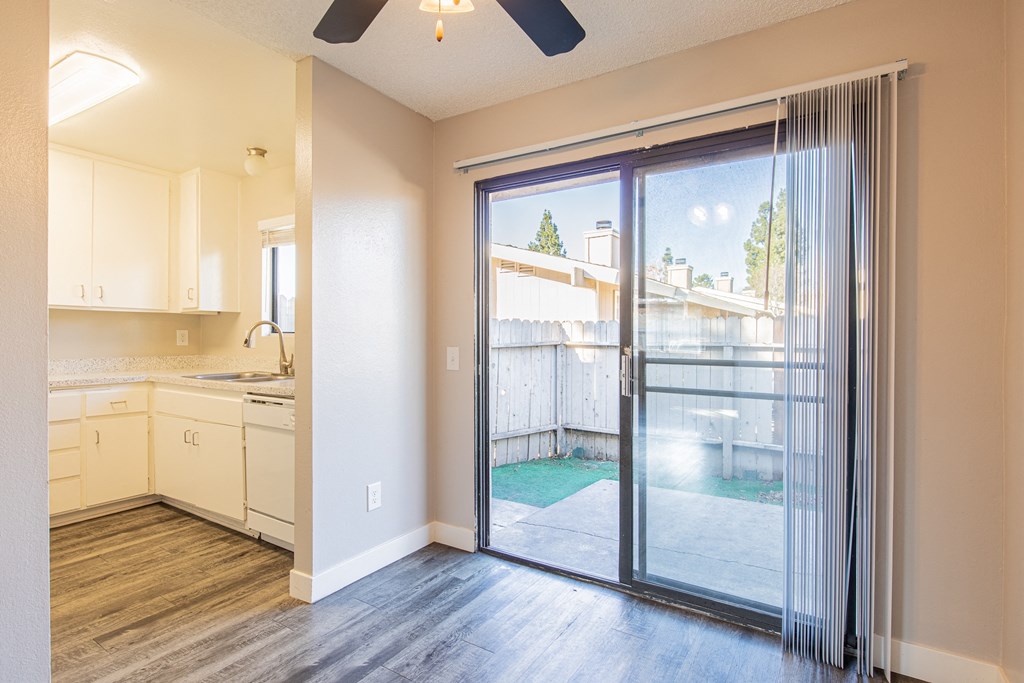 an empty kitchen with sliding glass doors to a backyard pool