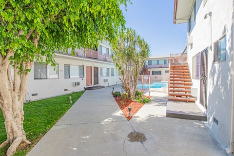 the backyard of a house with a pool and stairs