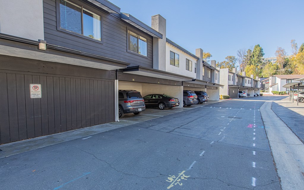 a parking lot with cars parked in front of a building