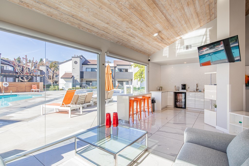 a living room with a glass table and a pool