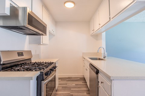 A kitchen with a stove top oven and a microwave.