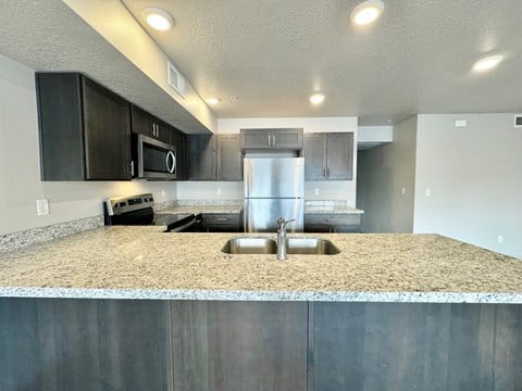 a kitchen with stainless steel appliances and granite counter tops