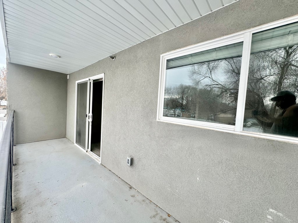 a view of the side of a house with a window and a door