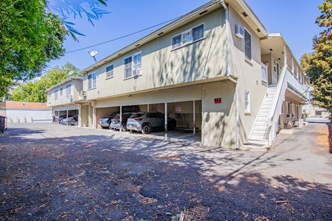 A two-story building with a parking lot in front.