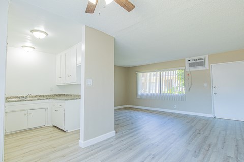 A kitchen with white cabinets and a countertop is shown.