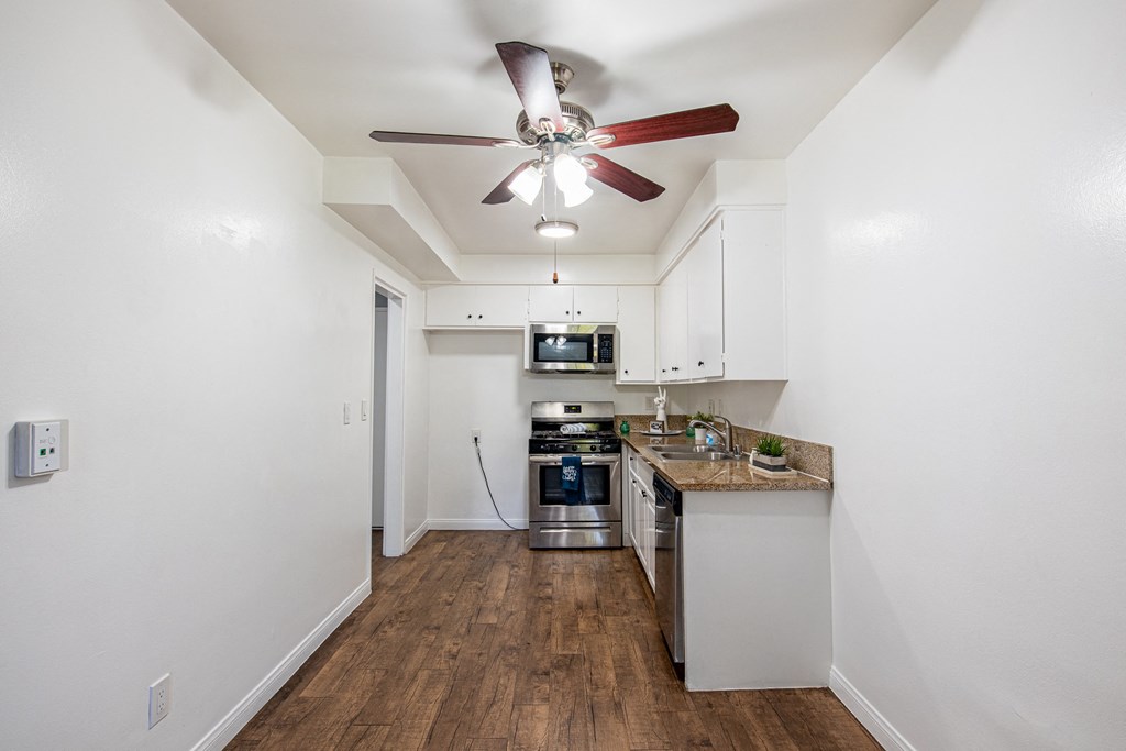A kitchen with a fan on the ceiling.