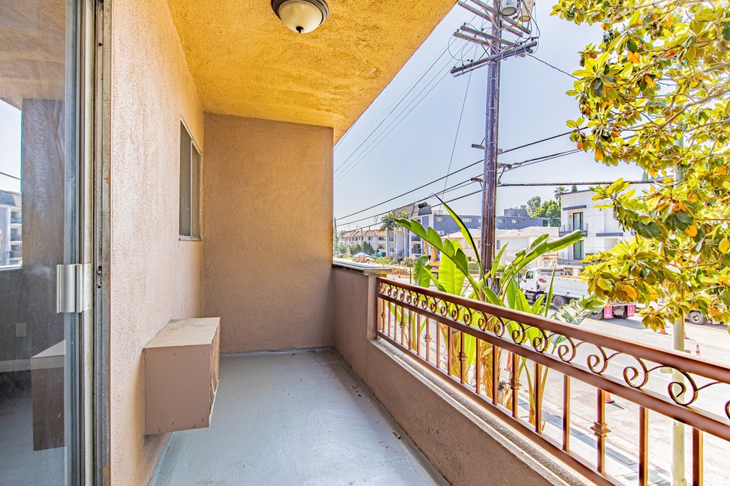 A balcony with a metal railing and a window.