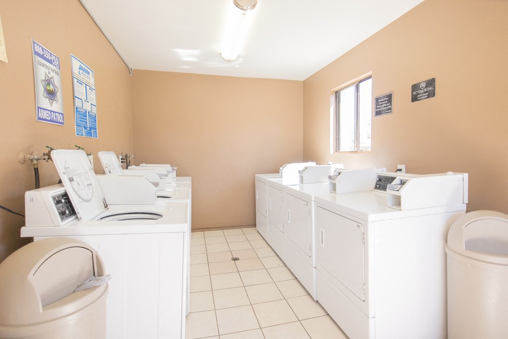 a laundry room with washes and dryers and a toilet