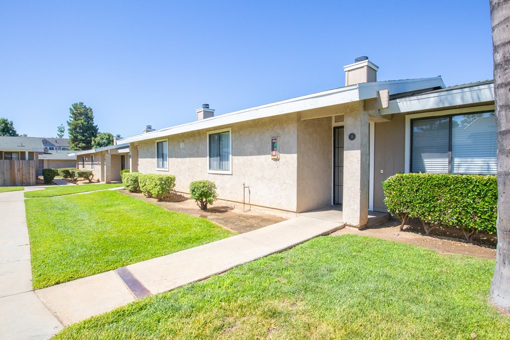 a white house with a yard and a sidewalk