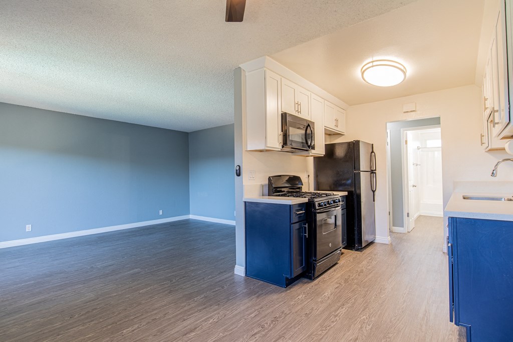 A kitchen with blue cabinets and appliances.