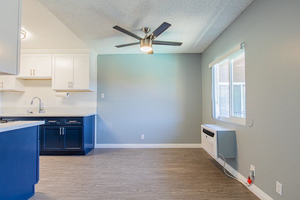 A kitchen with blue cabinets and a white countertop.