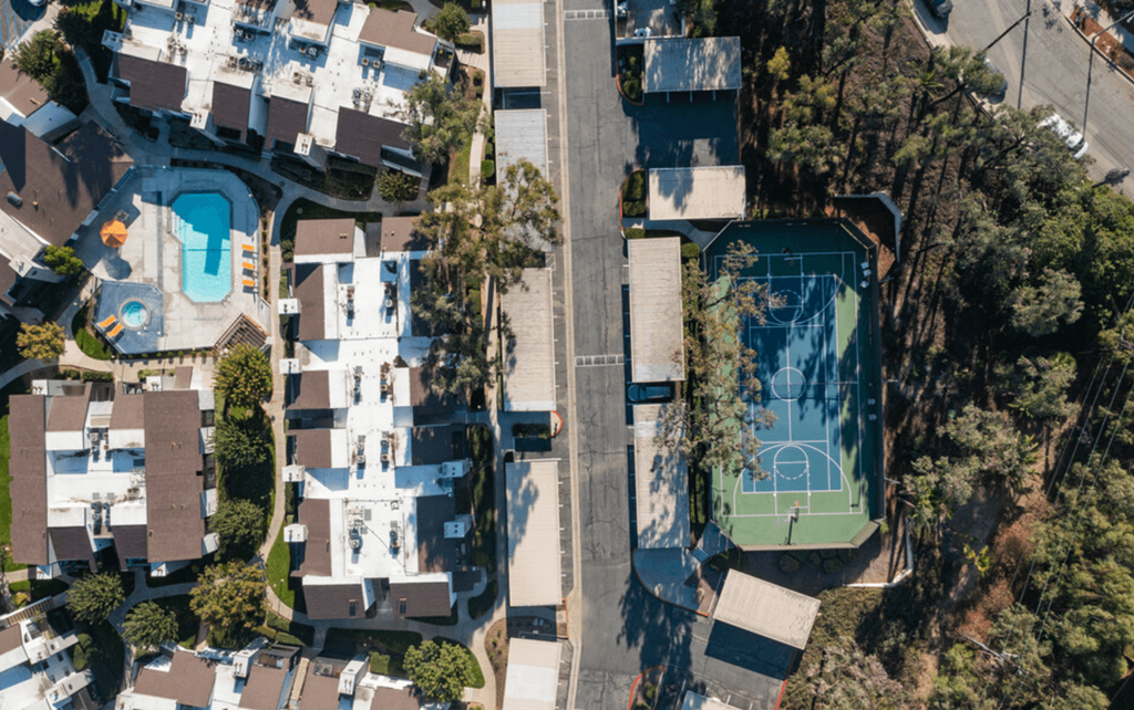 arial view of a house with a tennis court