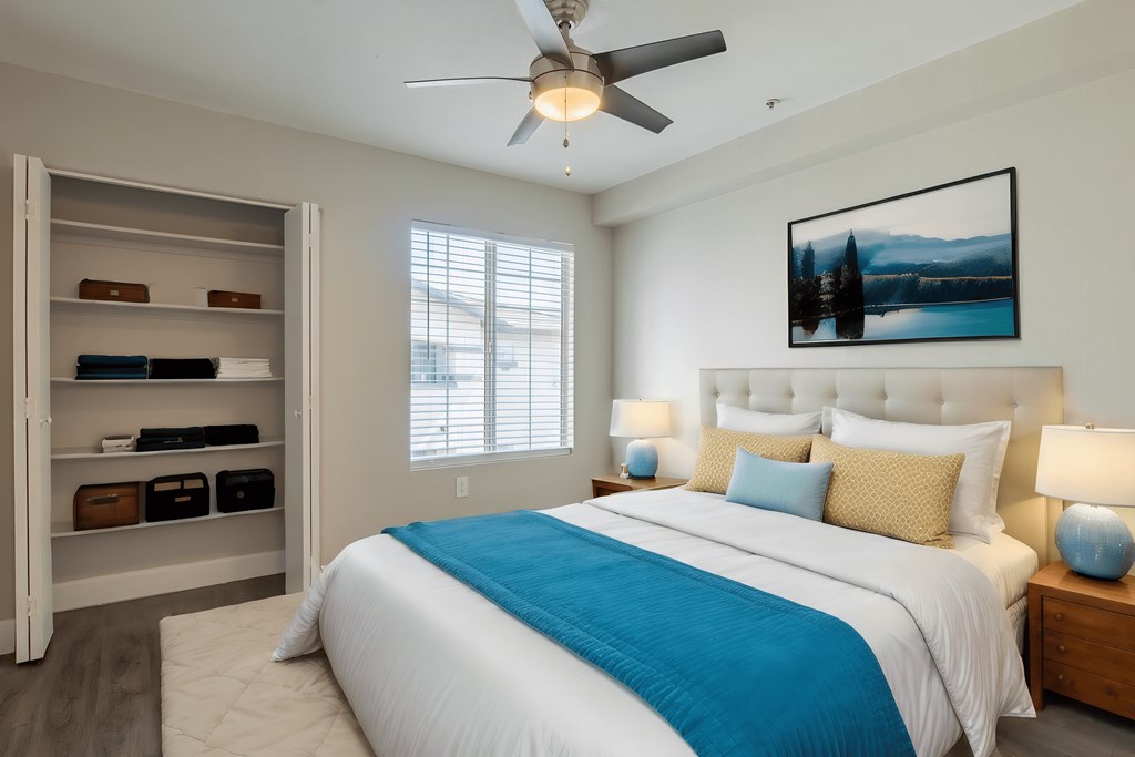 a bedroom with a large bed and a ceiling fan