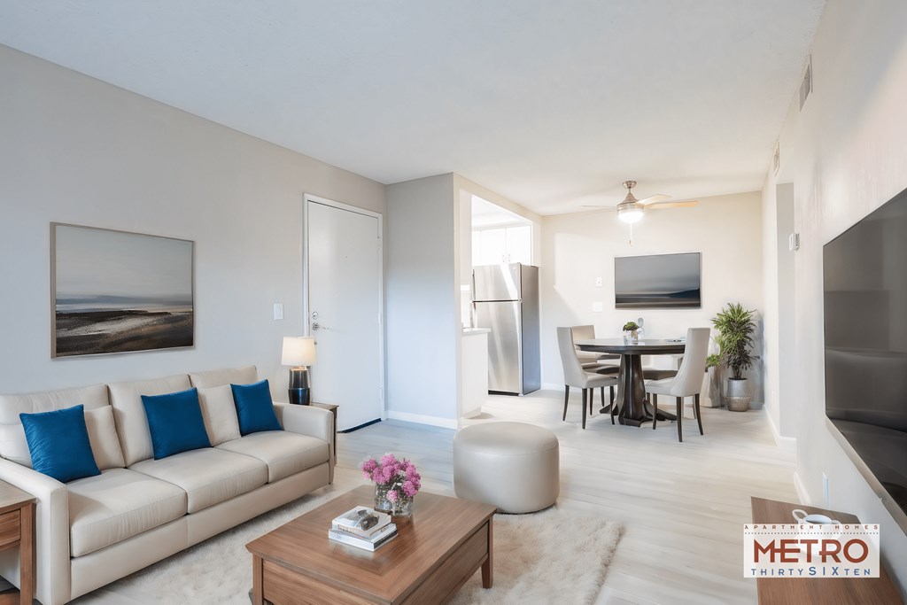 a living room and dining room with a couch and a table