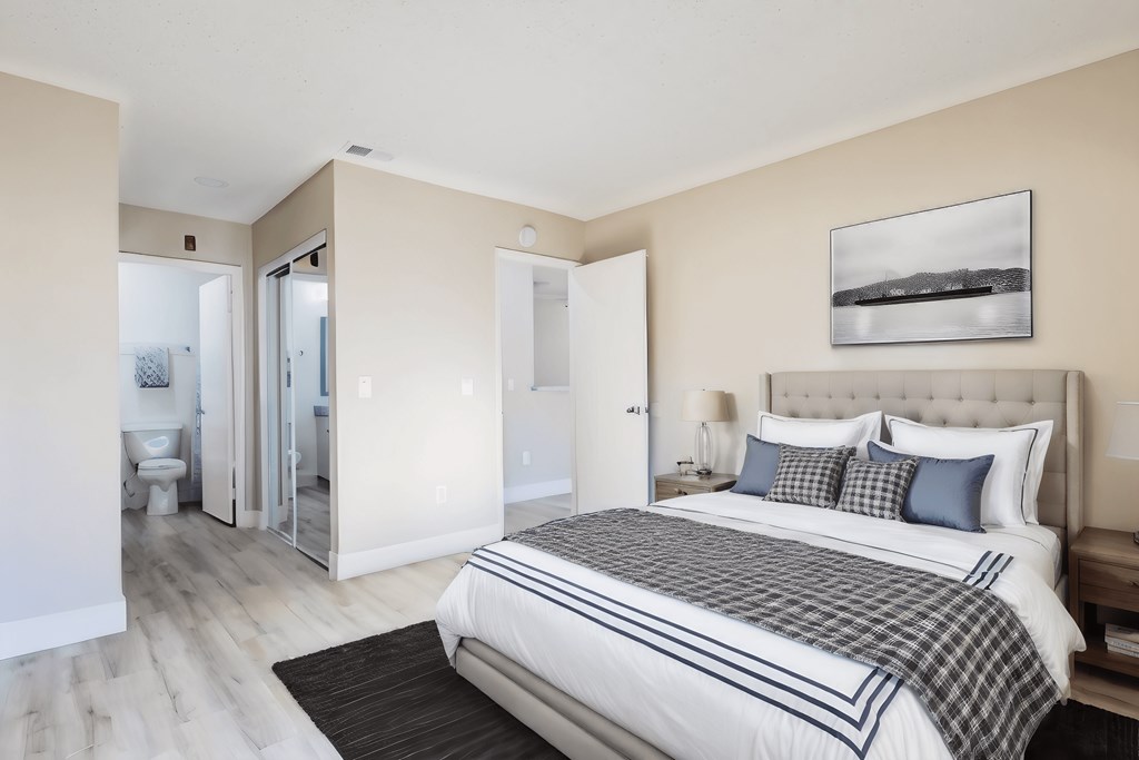 a bedroom with a bed and a bathroom with a shower