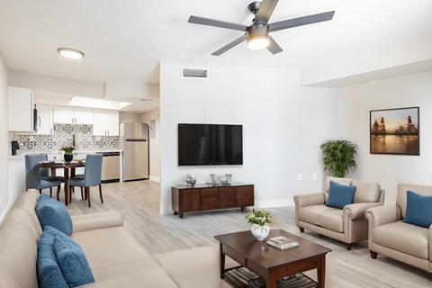 a living room with couches and a table with a tv