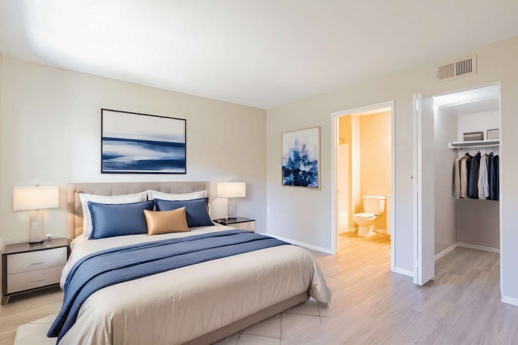 a bedroom with a bed and a closet and a bathroom