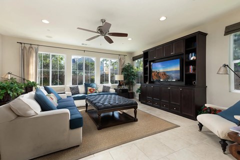 a living room filled with furniture and a large tv