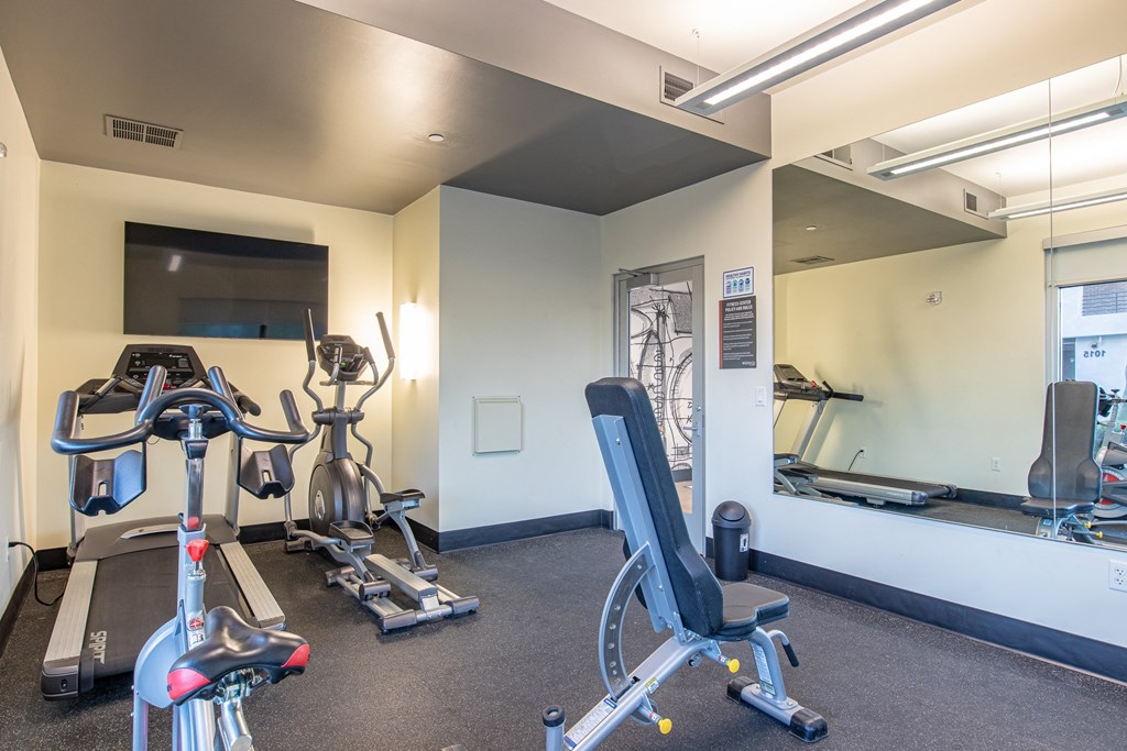 a gym with treadmills and other exercise equipment at the belgard apartments