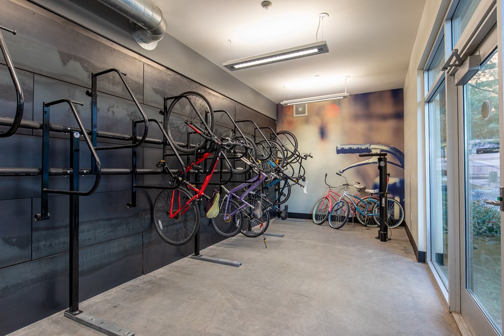 a row of bikes hanging on a wall in a room with a window