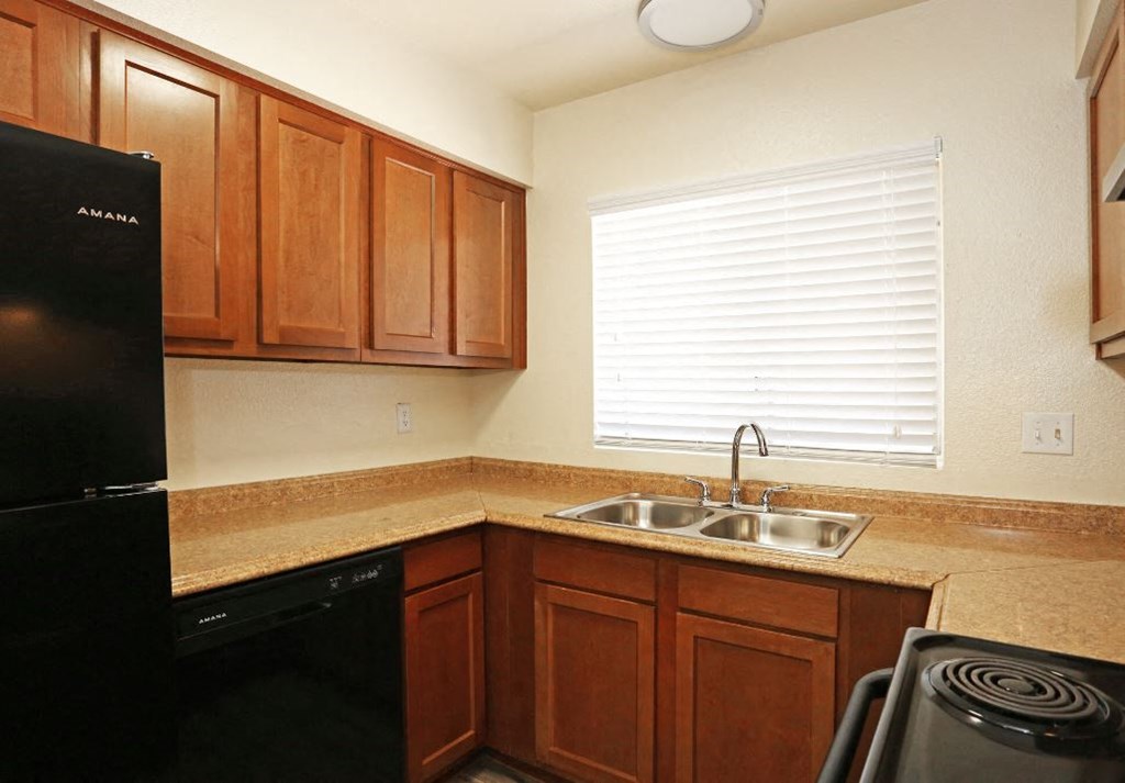 a kitchen with a sink and a stove and a window