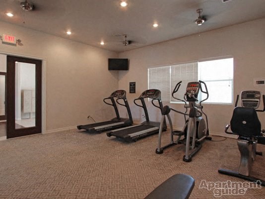 a gym with exercise equipment and a window