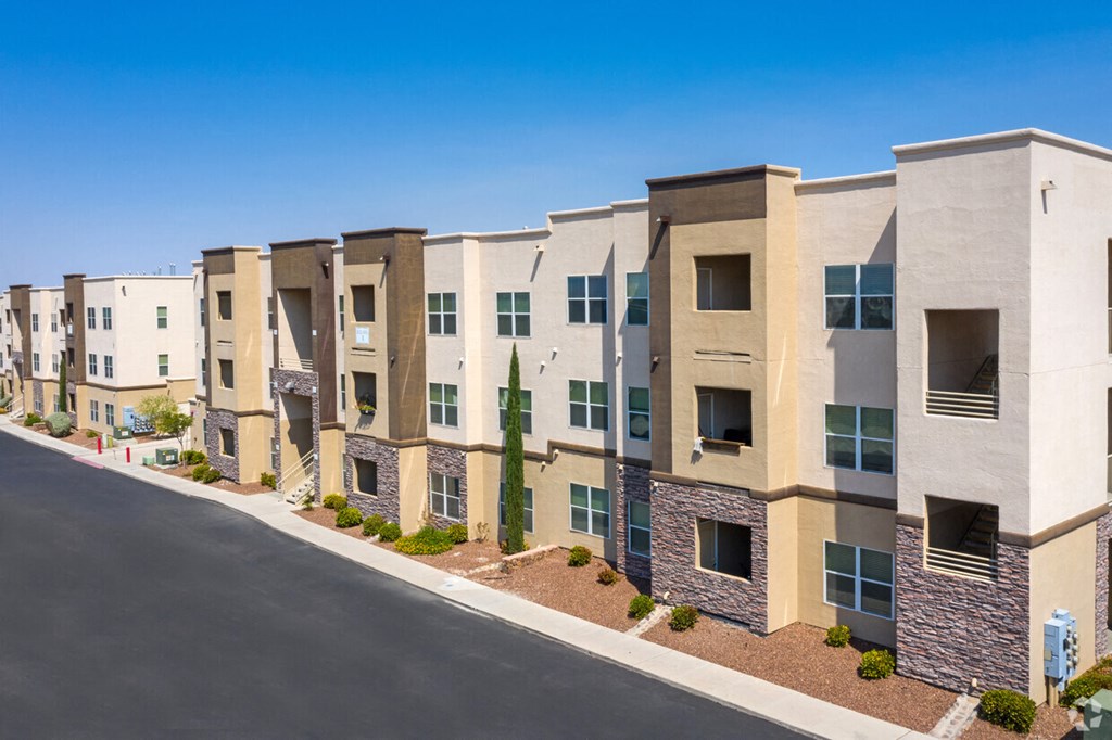 an apartment building with a street in front of it