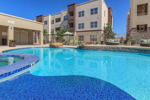 a large swimming pool in front of an apartment building
