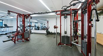 A gym with a variety of equipment including a leg press machine.